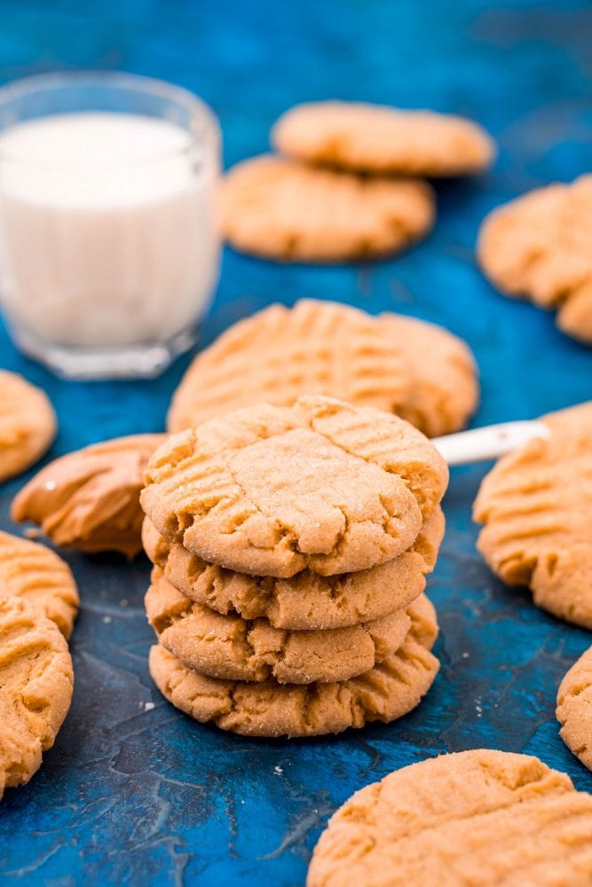 picture of peanut butter cookies stacked on a blue table