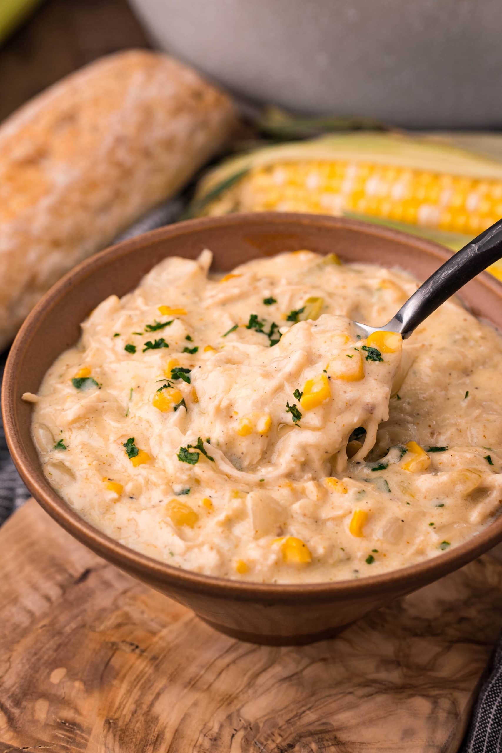 Easy corn chowder recipe served in a bowl with a spoon.
