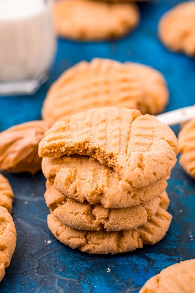 picture of peanut butter cookies stacked on a blue table