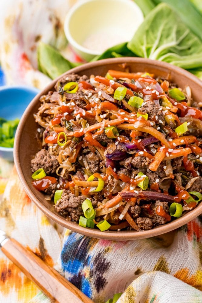 picture of egg roll in a bowl with bok choy in the background