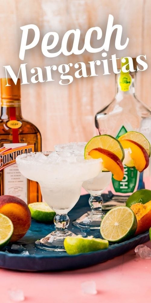 Picture of margarita glasses with peach slices in front of a bottle of tequila and a bottle of cointreau