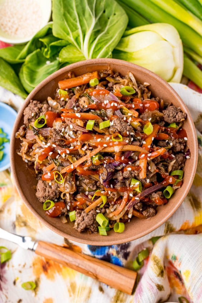 picture of egg roll in a bowl with bok choy in the background