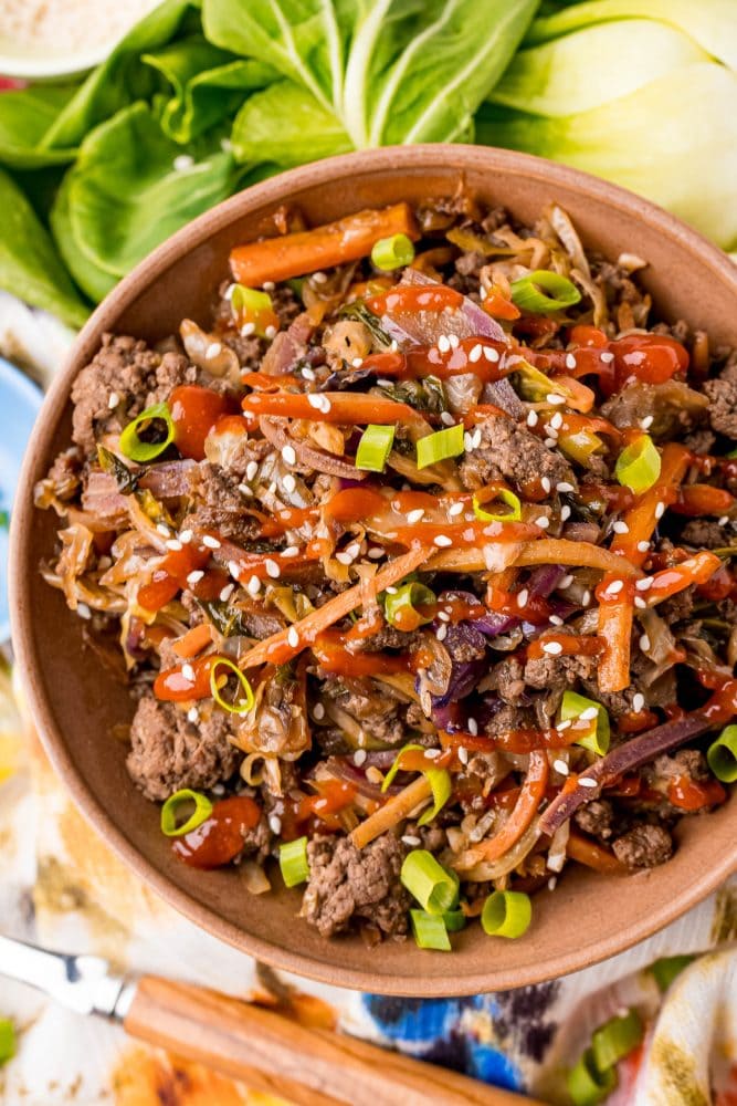 picture of egg roll in a bowl with bok choy in the background