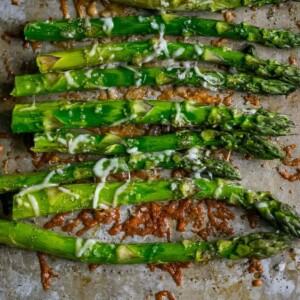 asparagus roasted on a baking sheet with parmesan and garlic