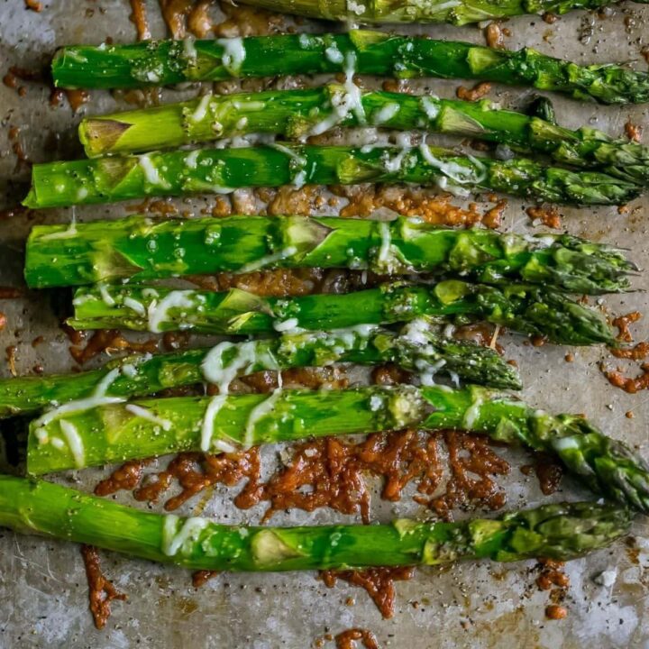 asparagus roasted on a baking sheet with parmesan and garlic