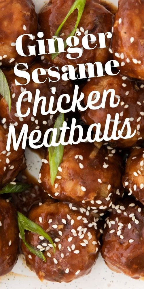 meatballs in sticky sauce with sesame seeds and green onions on it