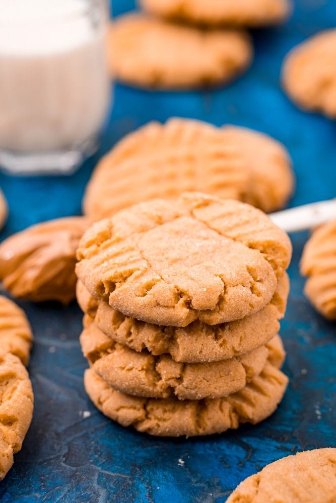 picture of peanut butter cookies stacked on a blue table