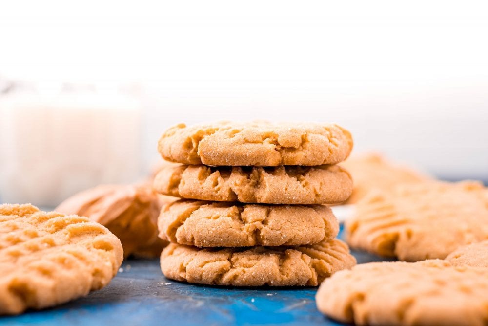 picture of peanut butter cookies stacked on a blue table