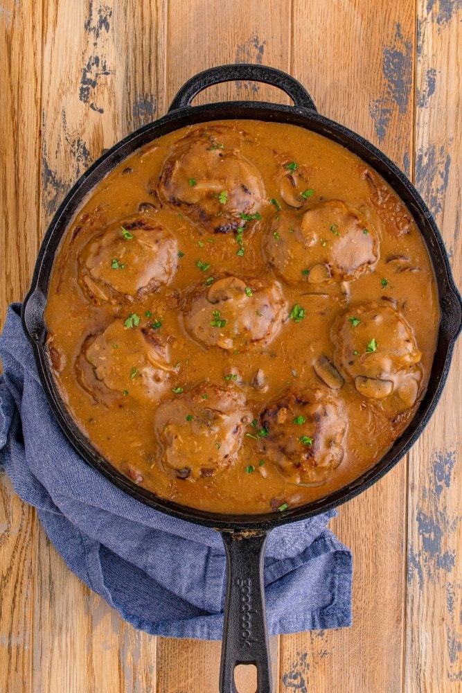 pot of brown gravy with breaded steak in it