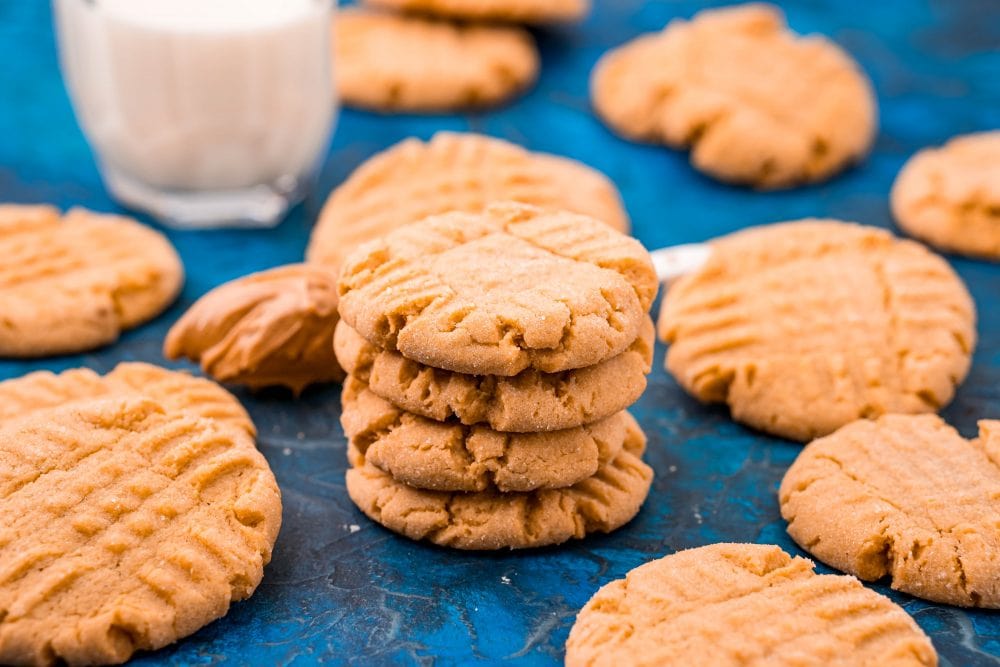 picture of peanut butter cookies stacked on a blue table