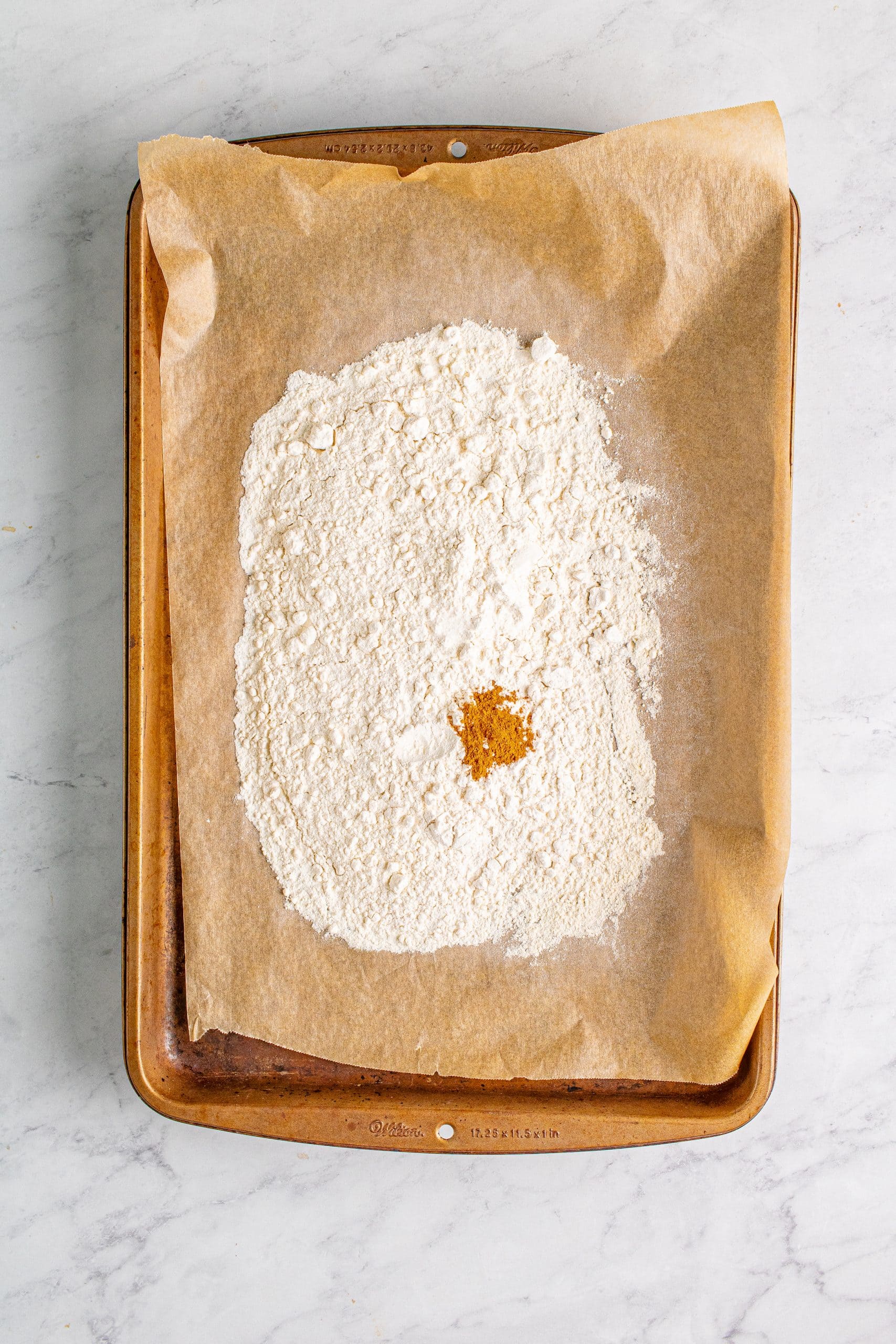 picture of flour and cinnamon on a baking sheet