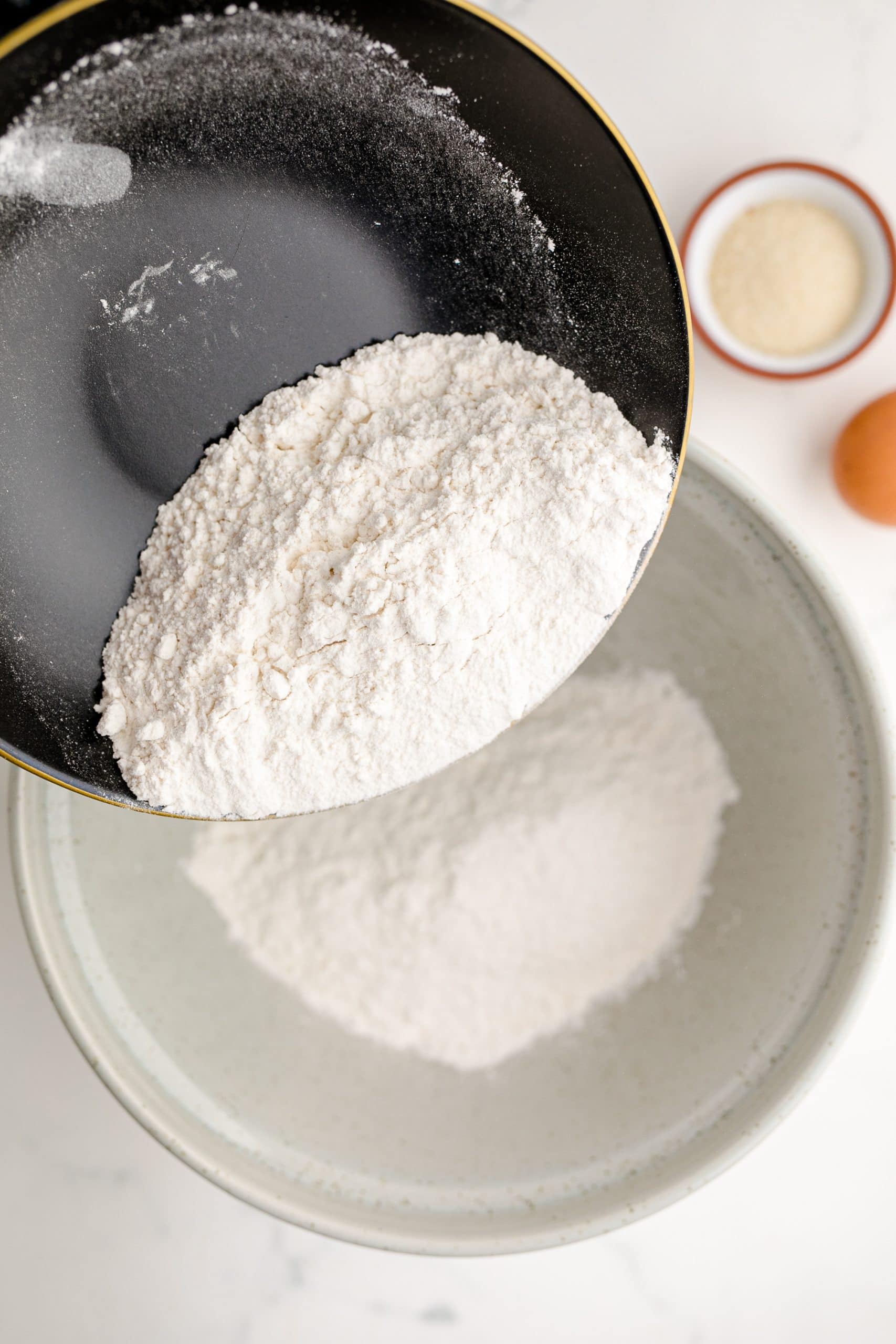 A bowl with flour and eggs, perfect for making a blueberry muffin recipe.