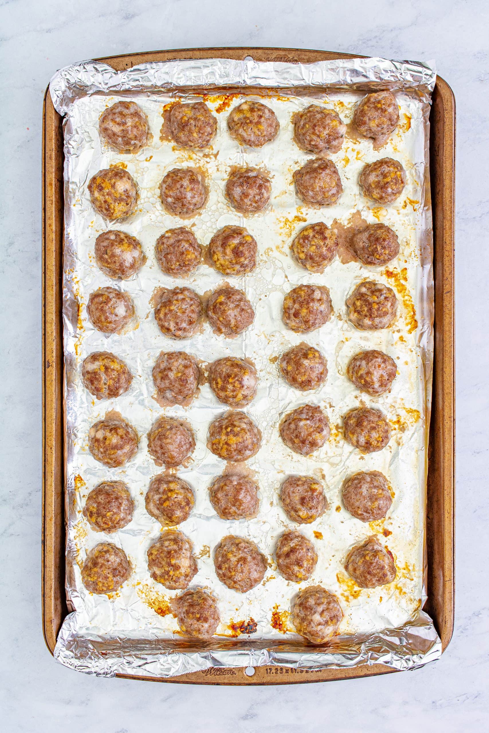 A baking sheet with meatballs on it, perfect for easy grape jelly or crockpot recipes.