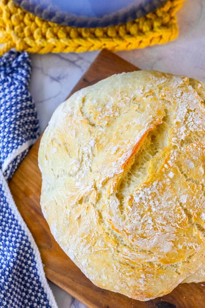 loaf of no knead bread on a cutting board