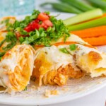 Buffalo chicken enchiladas with carrots and celery.