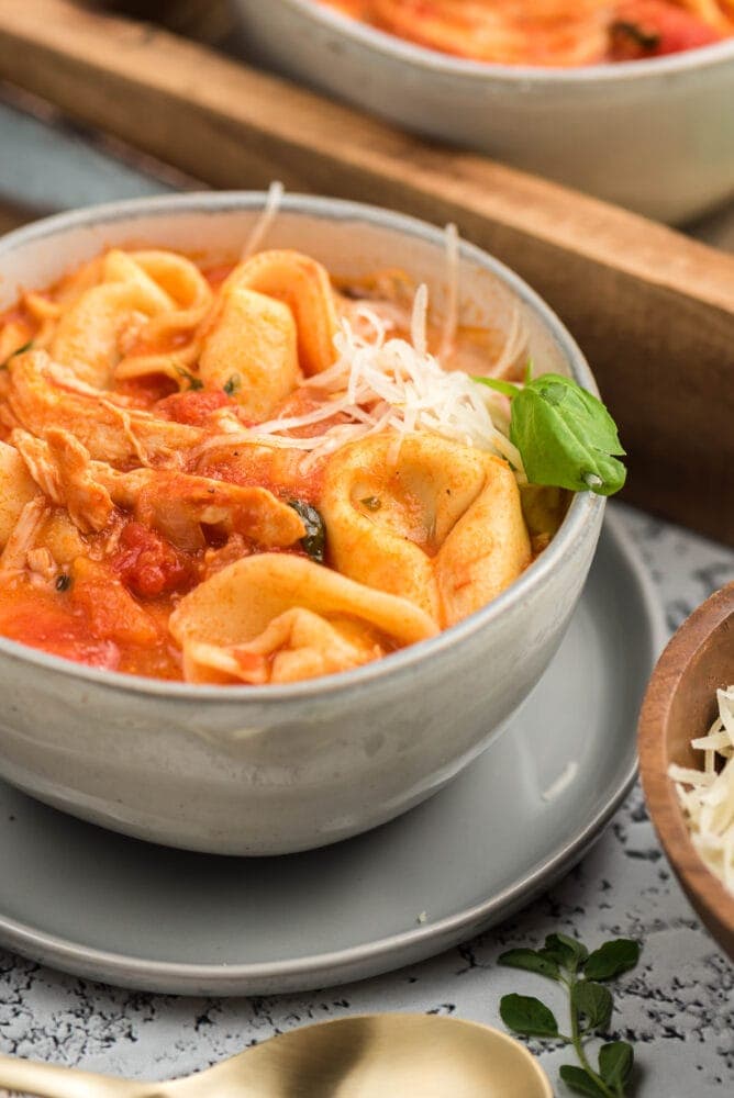 picture of tomato basil chicken tortellini soup in a bowl on a table