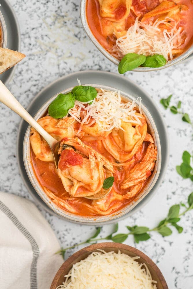 picture of tomato basil chicken tortellini soup in a bowl on a table