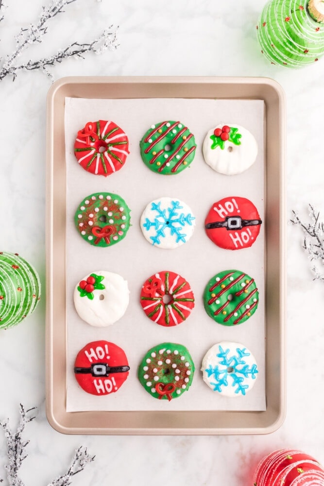 iced cookies that are decorated with candy to look like Christmas wreaths