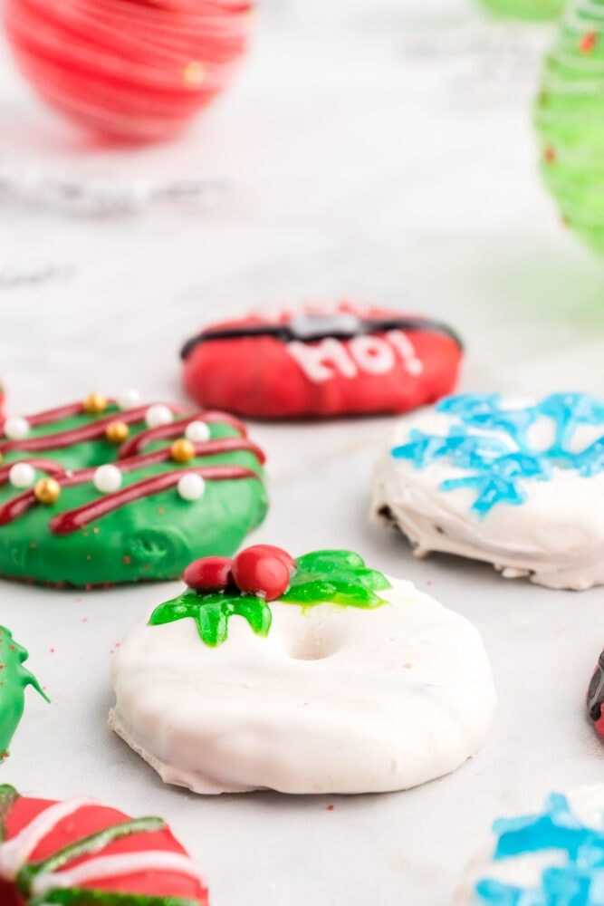 iced cookies that are decorated with candy to look like Christmas wreaths