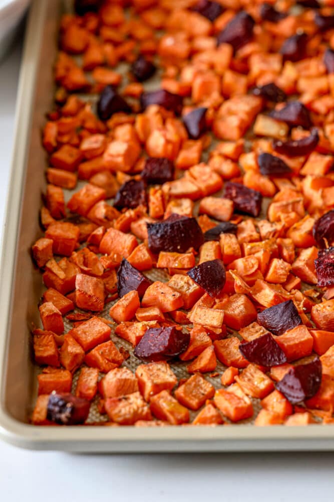 picture of roasted beets and sweet potatoes on a baking sheet