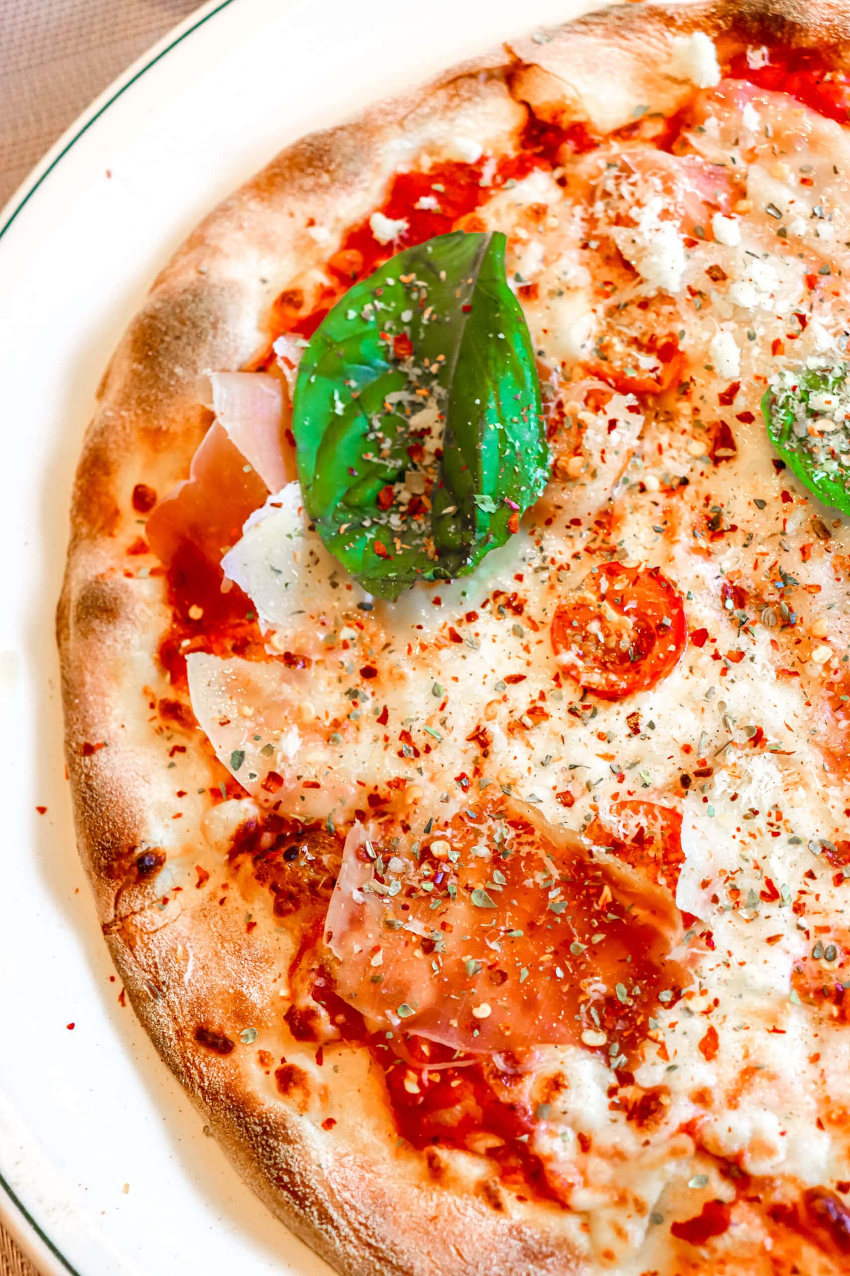 Your Ultimate Dining Guide for the Majestic Princess 28 A tempting slice of Alfredo's pizza on a plate, showcasing its crispy crust and fresh toppings.