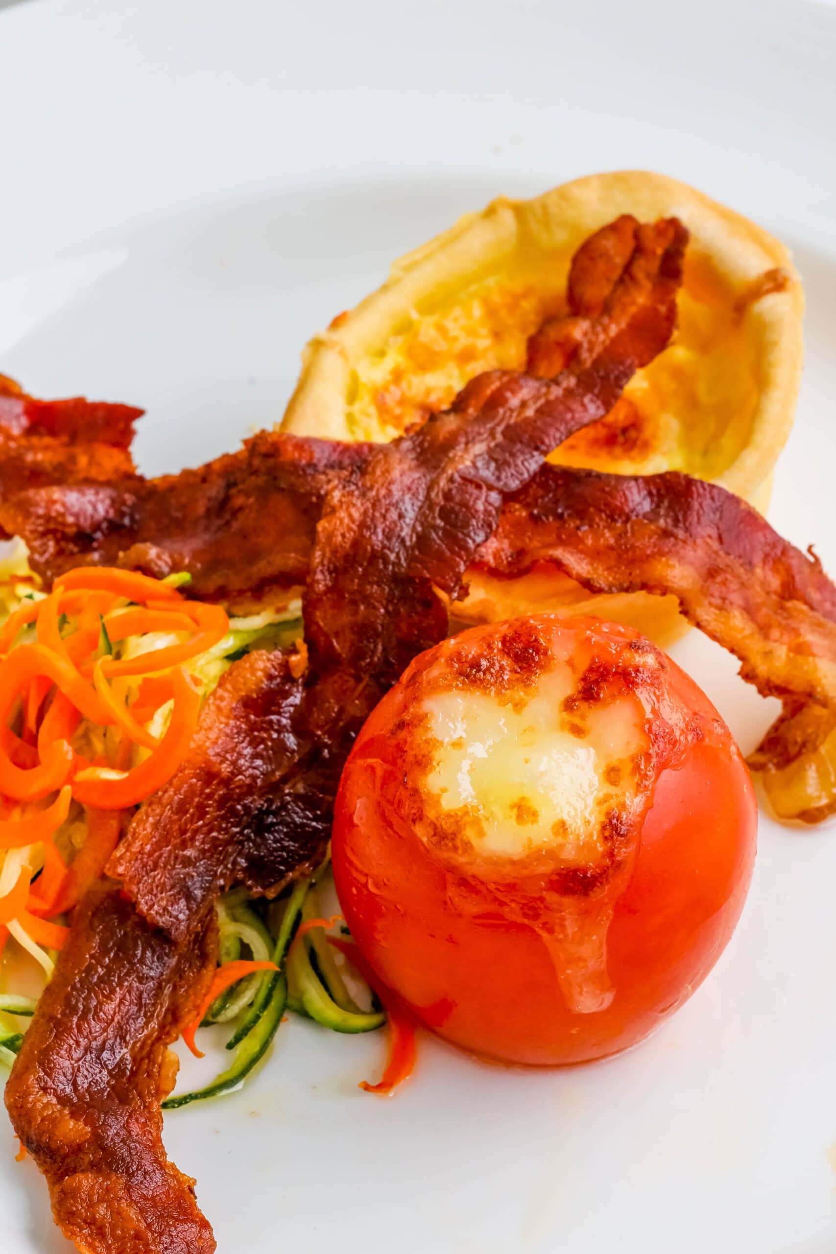 Your Ultimate Dining Guide for the Majestic Princess 39 A plate featuring crispy bacon, ripe tomatoes, and tender zucchini, part of a delightful Majestic Princess breakfast.