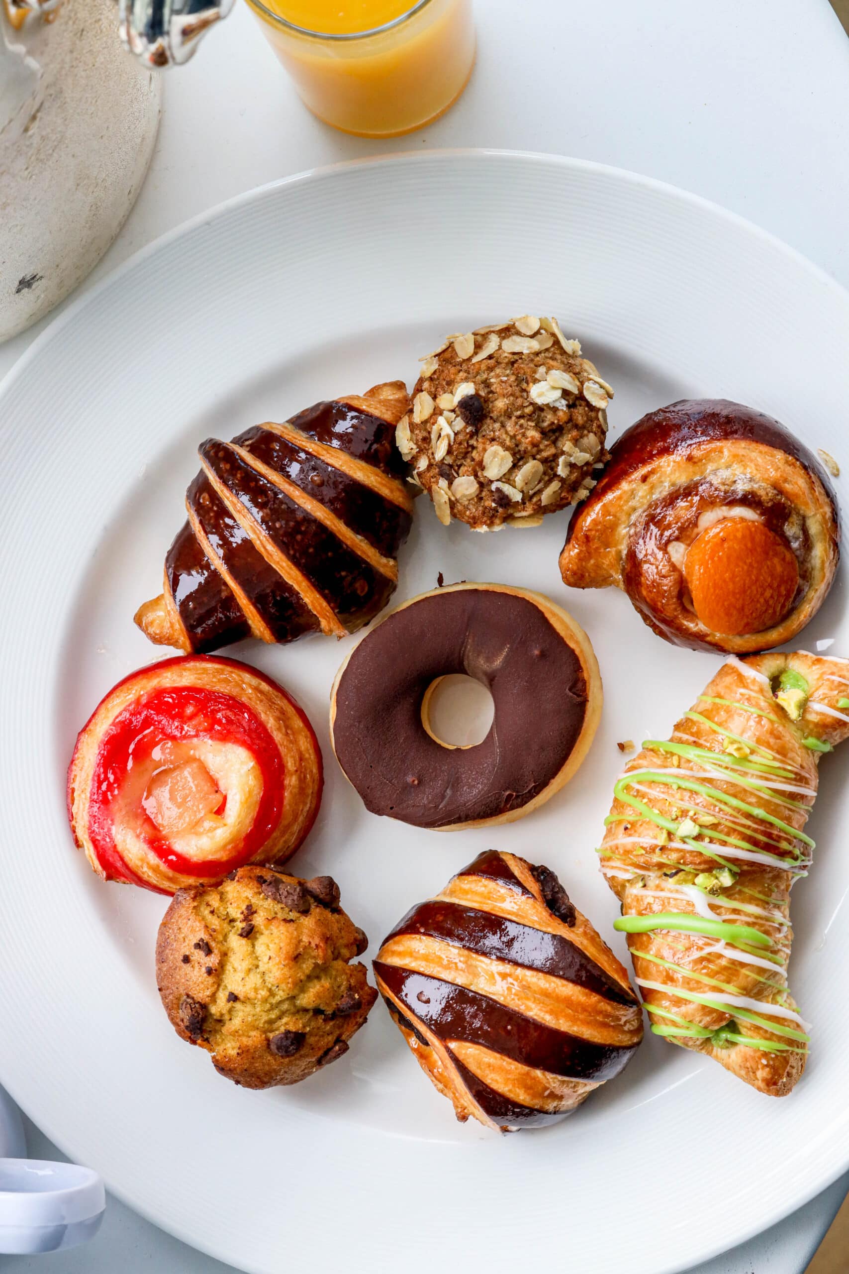 Your Ultimate Dining Guide for the Majestic Princess 45 A white plate showcasing a variety of delicious pastries, ready for a delightful breakfast experience.