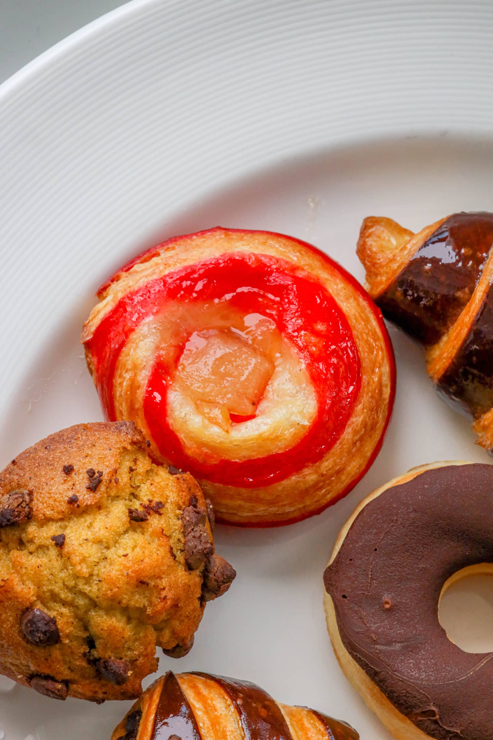 Your Ultimate Dining Guide for the Majestic Princess 43 A diverse selection of pastries elegantly served on a white plate aboard the Majestic Princess, inviting guests to a sweet morning treat.