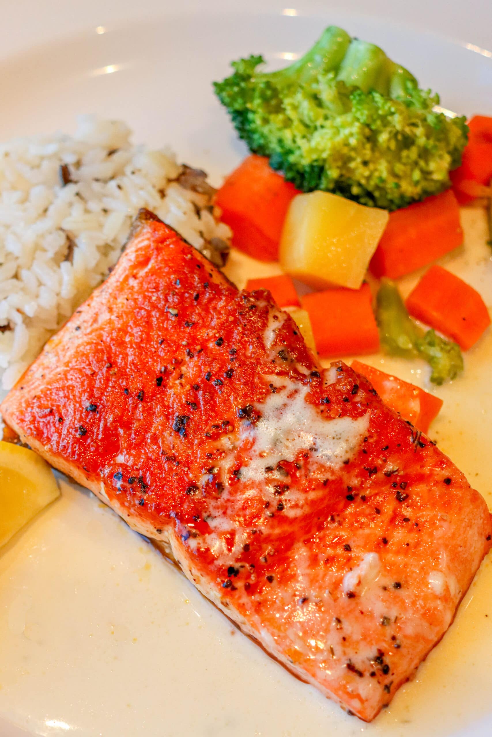Your Ultimate Dining Guide for the Majestic Princess 26 A vibrant and nutritious plate of salmon, rice, broccoli, and carrots, showcasing the healthy and delicious Princess Cruises food on Majestic Princess.