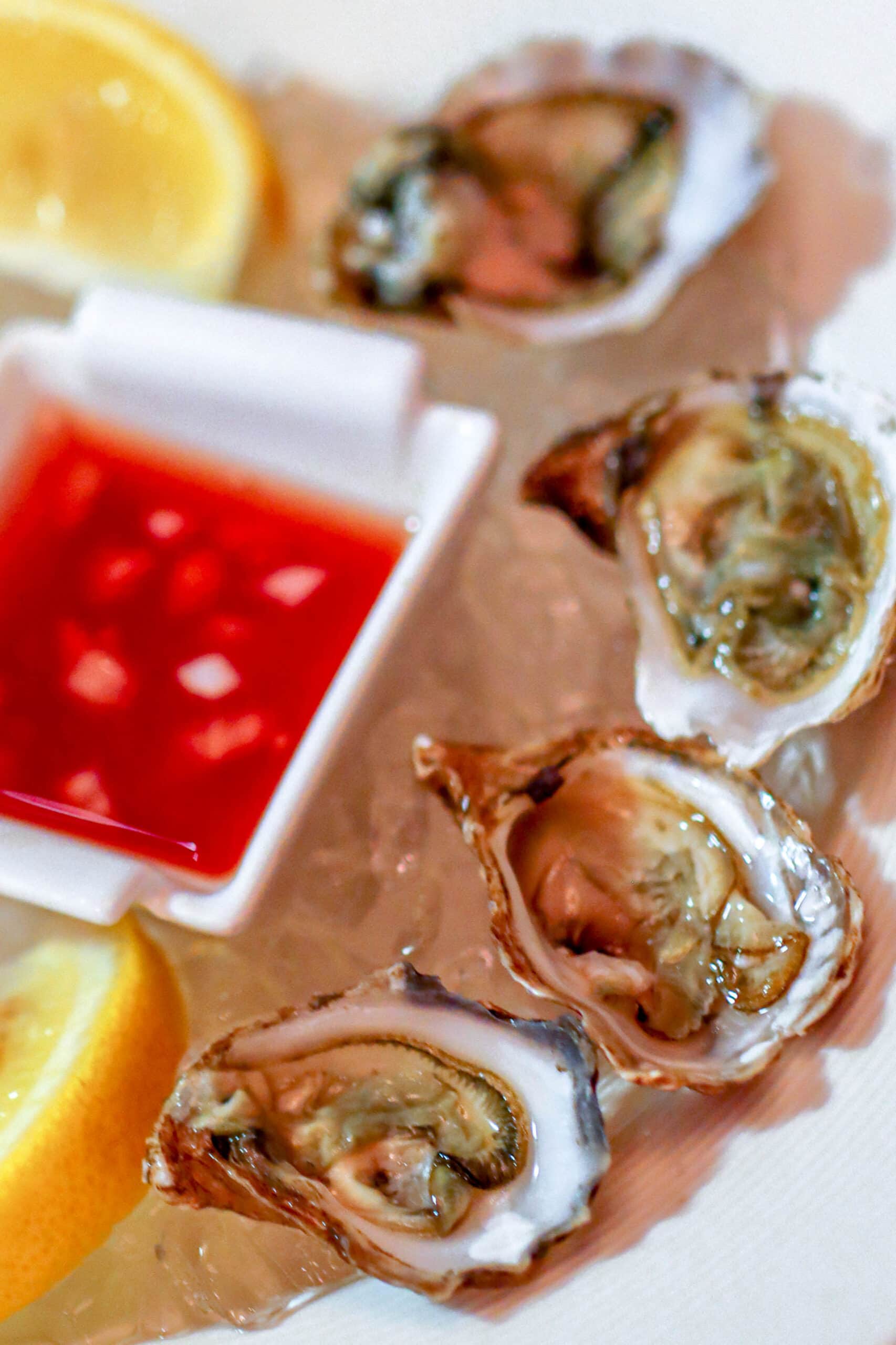 Your Ultimate Dining Guide for the Majestic Princess 20 Fresh, briny oysters served with a tantalizing sauce, a gourmet appetizer at the Crown Grill on Majestic Princess.