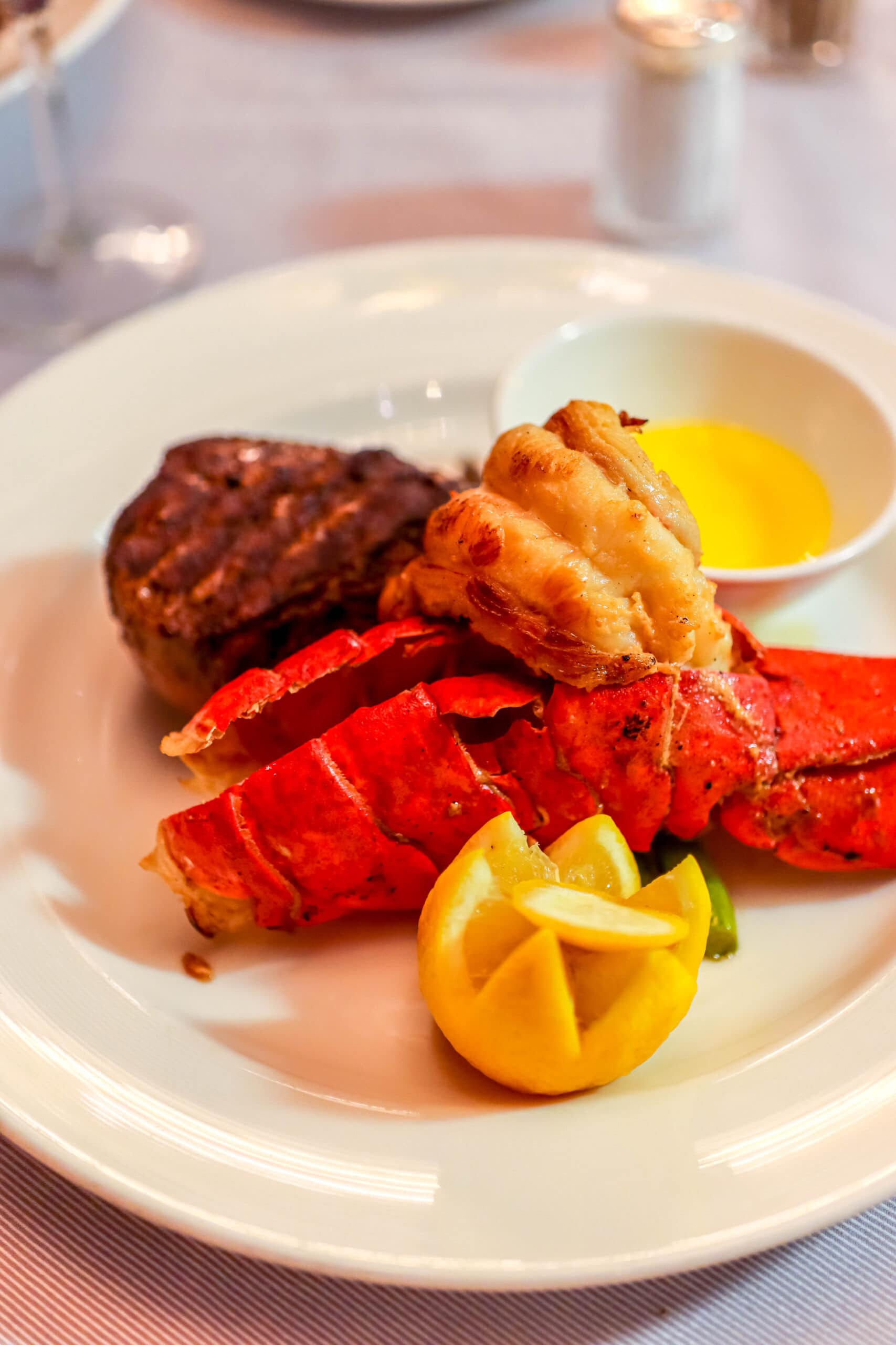 Your Ultimate Dining Guide for the Majestic Princess 23 A majestic plate featuring a succulent lobster tail paired with a perfectly grilled steak, the ultimate surf and turf at Crown Grill.