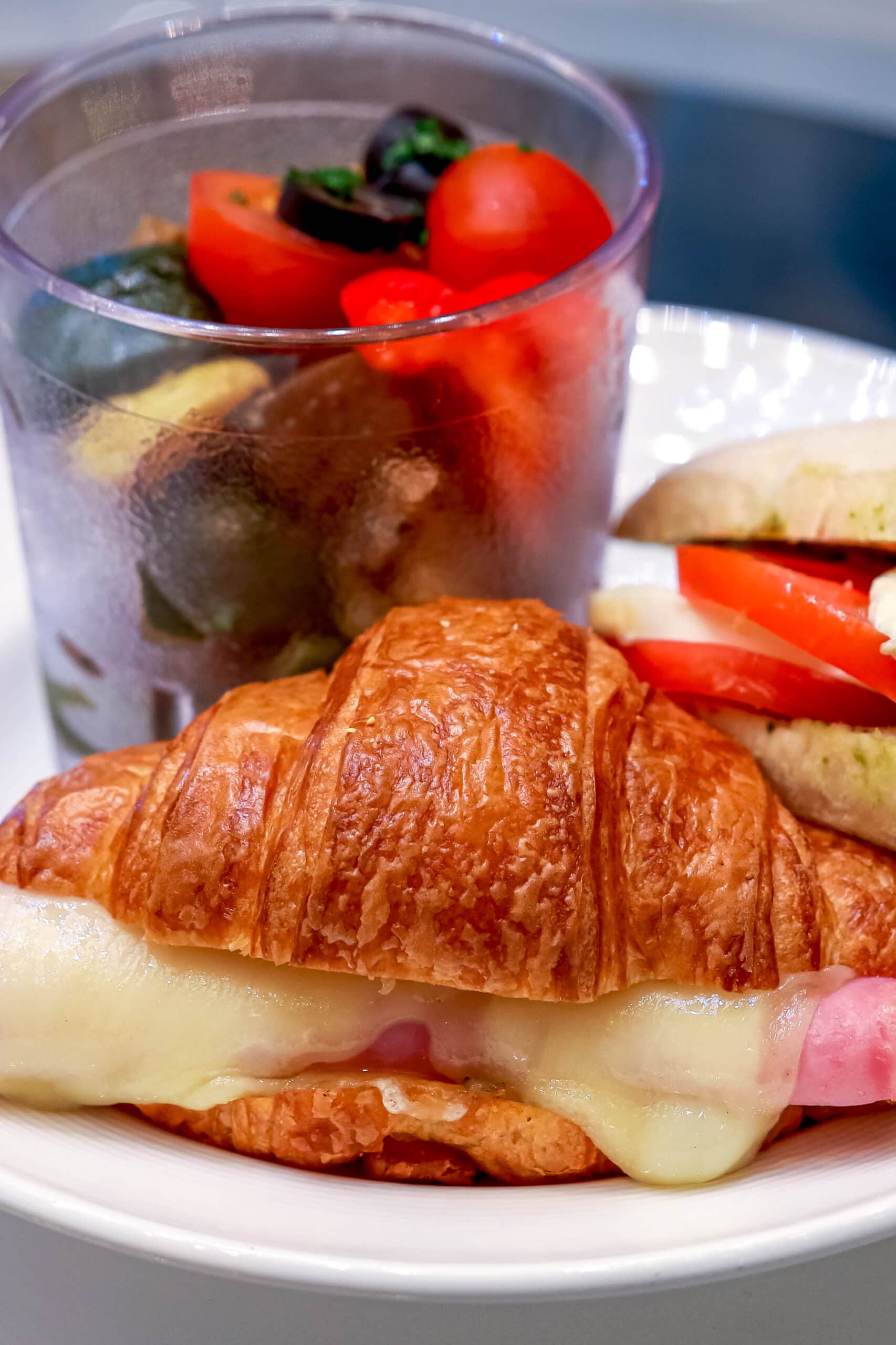 Your Ultimate Dining Guide for the Majestic Princess 36 A warm, gooey croissant grilled cheese on a plate, a delightful snack from the International Cafe.