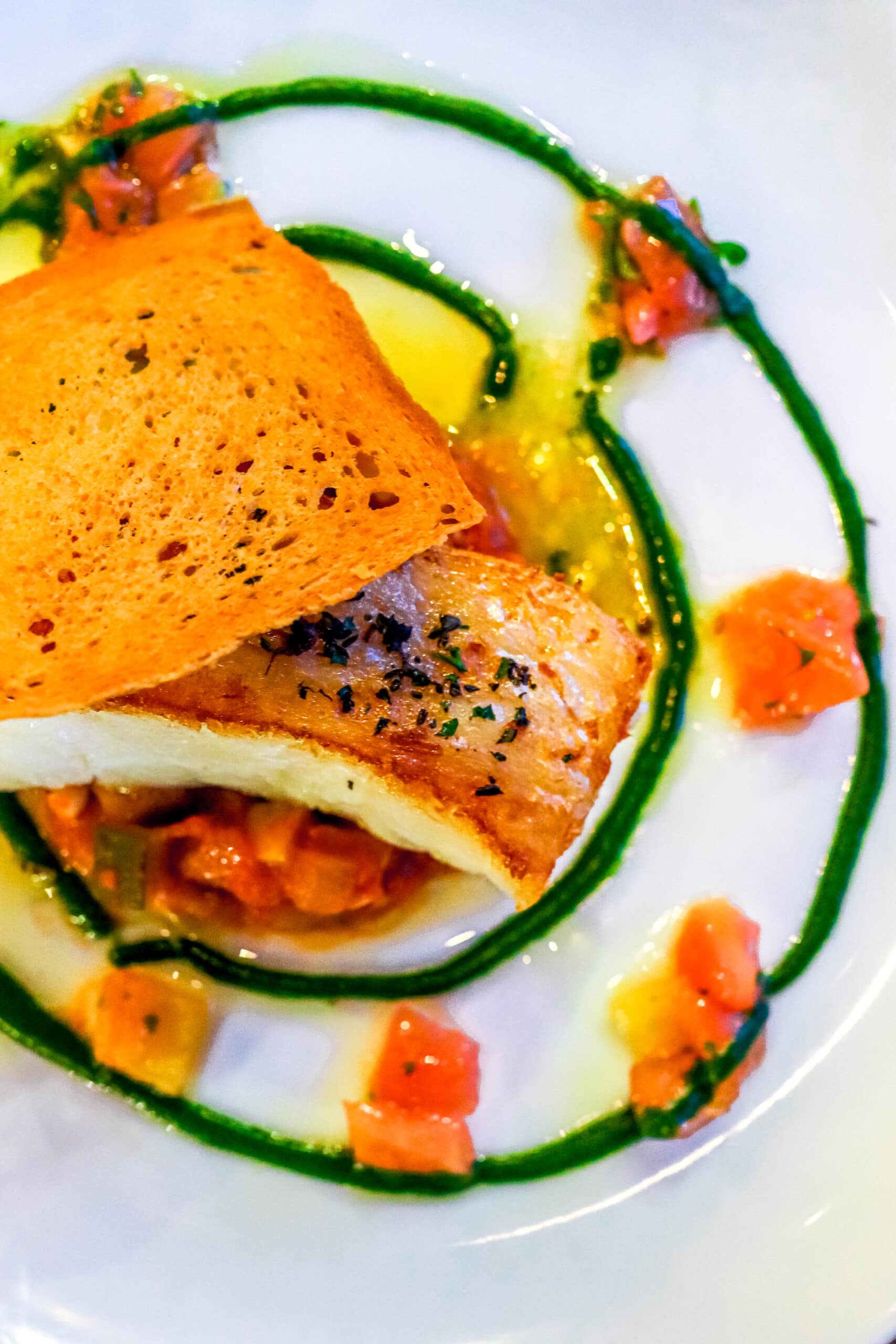 Your Ultimate Dining Guide for the Majestic Princess 5 Flaky and succulent seabass filet, beautifully presented with vibrant vegetables at Bistro Sur La Mer.