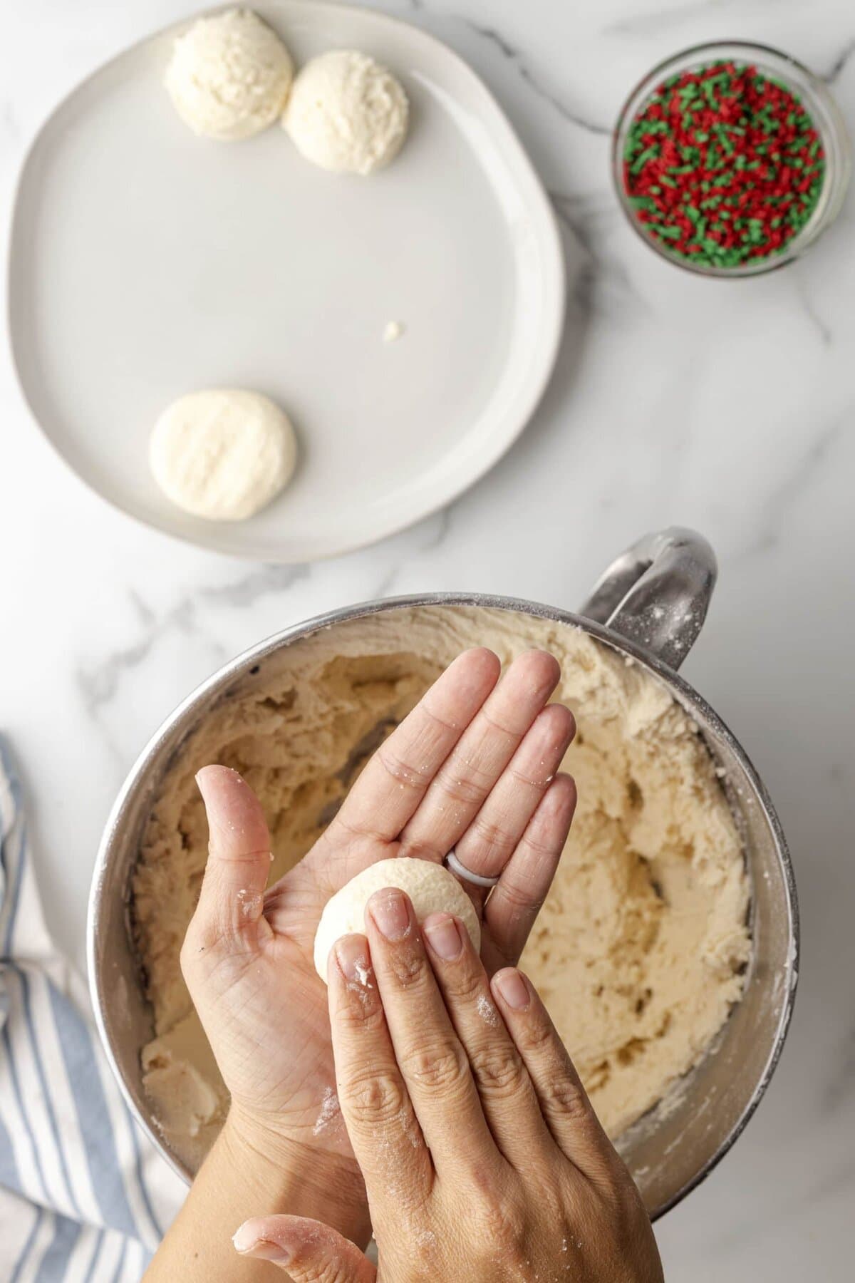 picture of hand rolling cookie dough