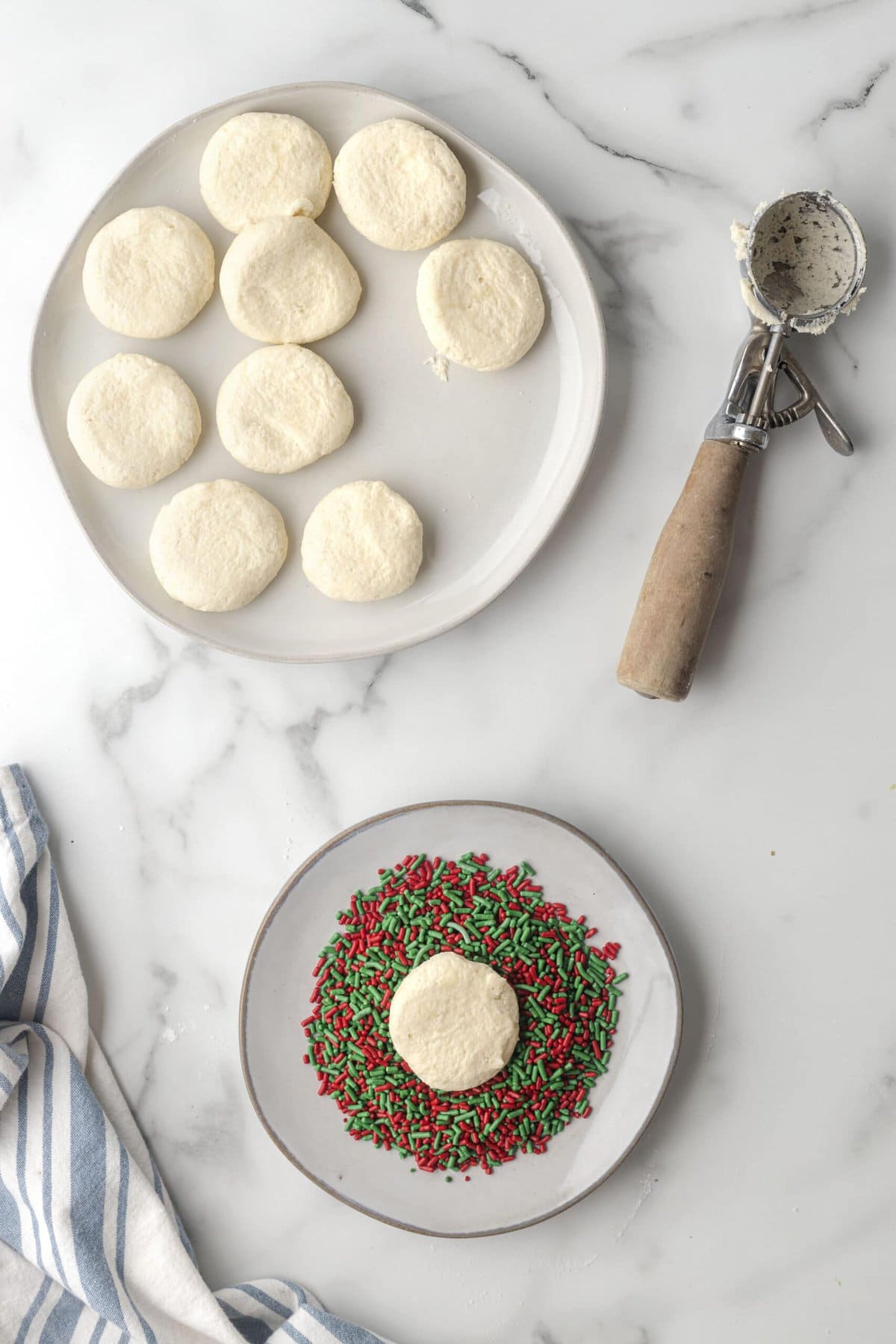 picture of cookies being pressed into sprinkles