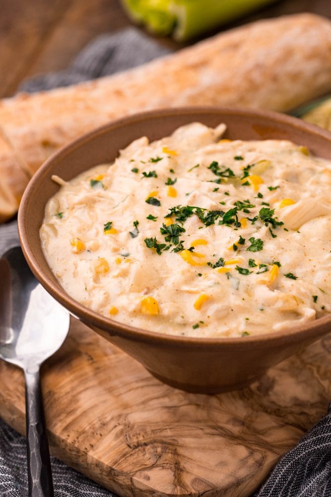 picture of shredded chicken in chowder with corn and parsley