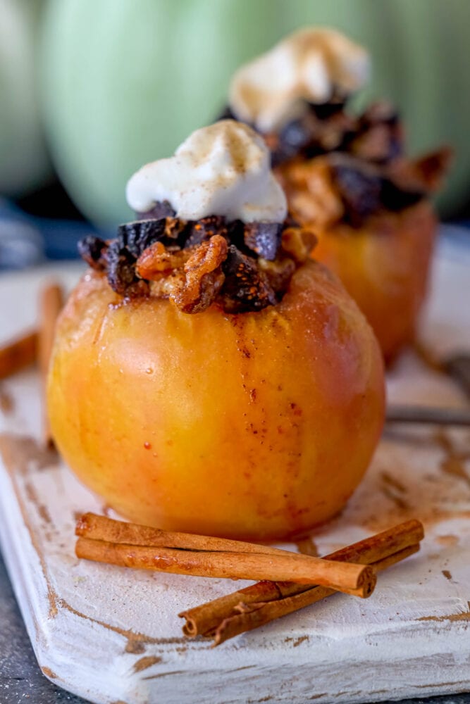 picture of baked apple on a plate topped with figs and whipped cream
