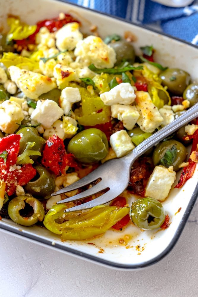 picture of baked olives and feta in a white glass dish