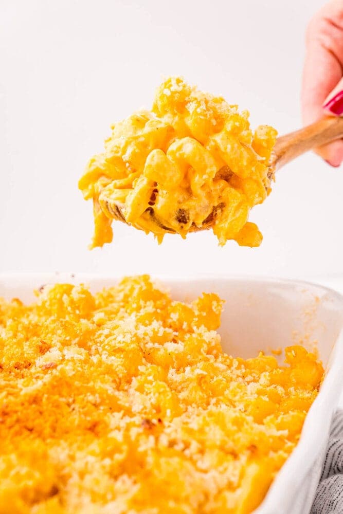 Fiery Buffalo Mac 'n' Cheese 11 A person enjoying a serving of buffalo chicken mac and cheese from a casserole dish.