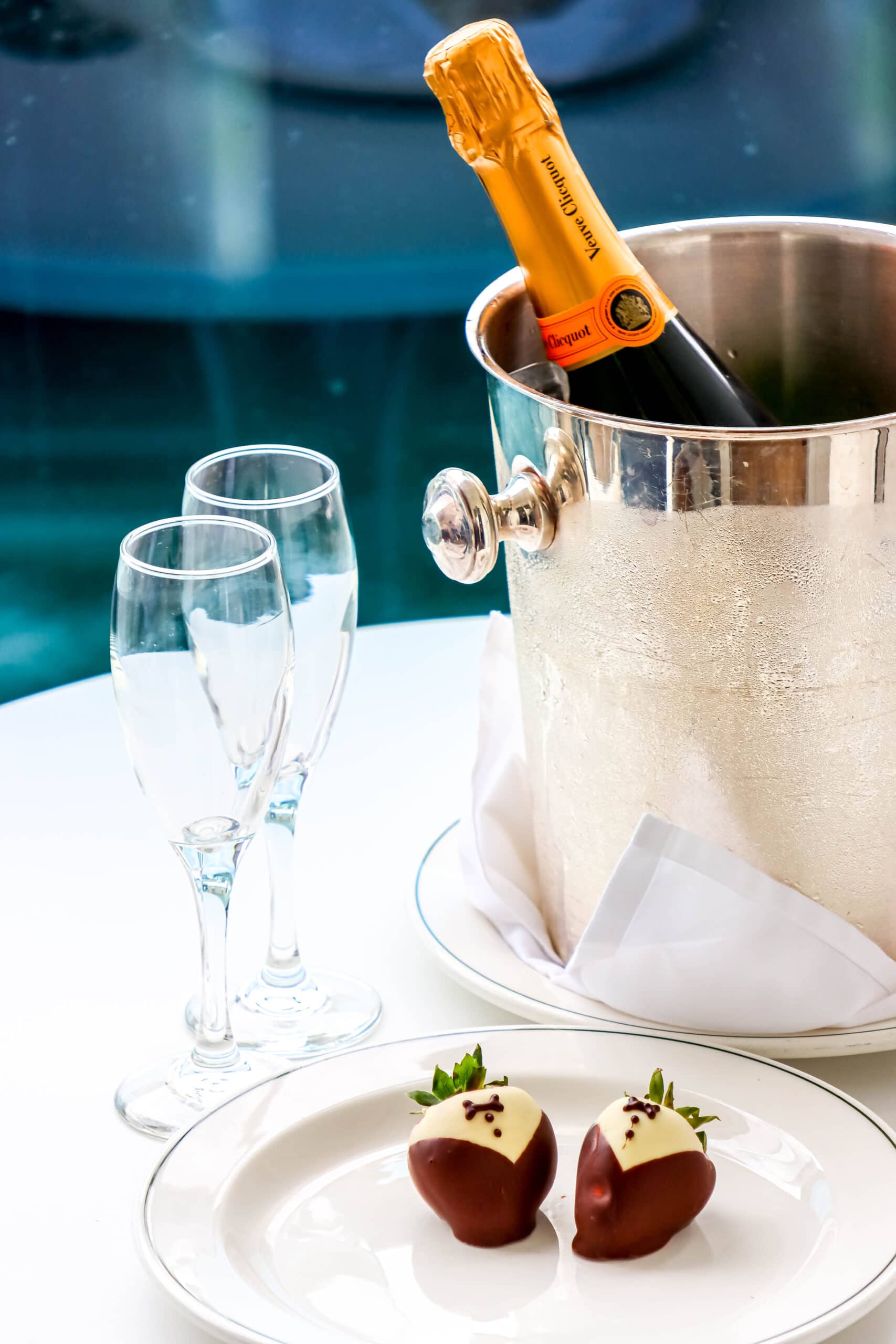Your Ultimate Dining Guide for the Majestic Princess 34 Two champagne flutes and a chilled bottle of Veuve Clicquot in a bucket, ready for a romantic toast on a balcony.