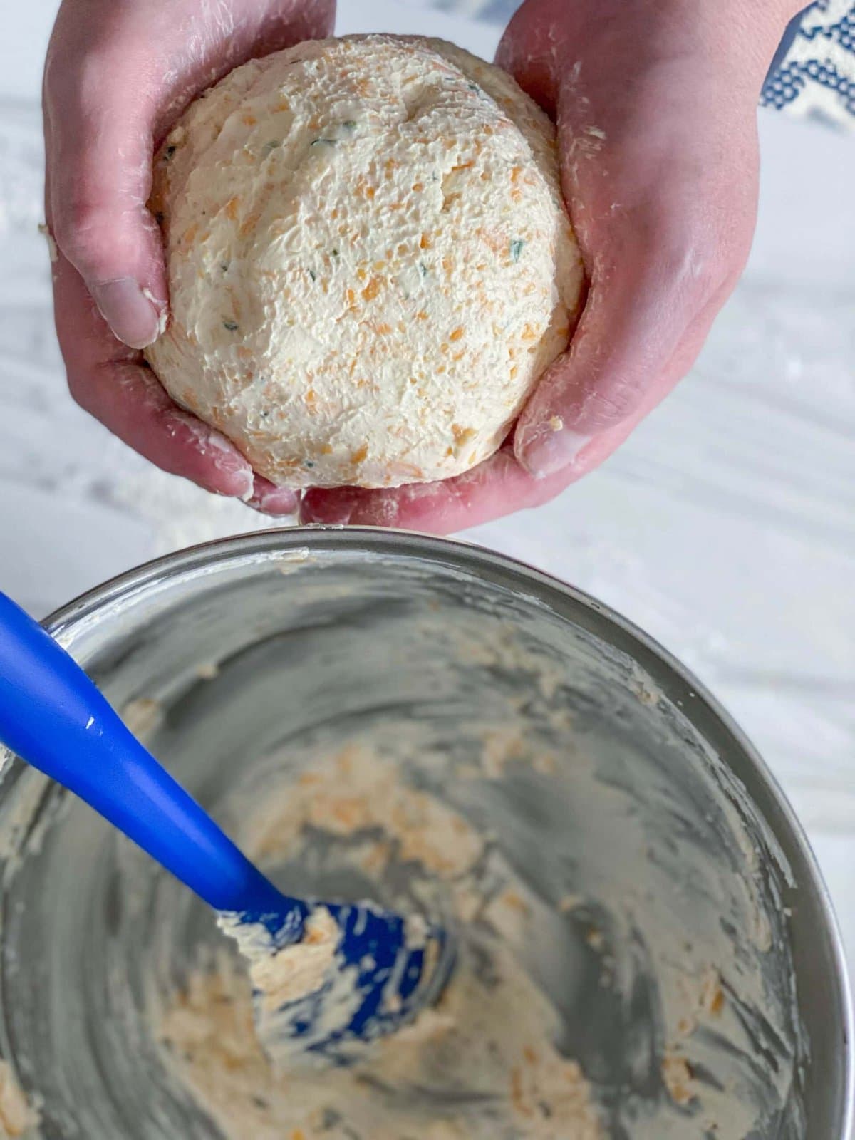 picture of hand holding cheese ball