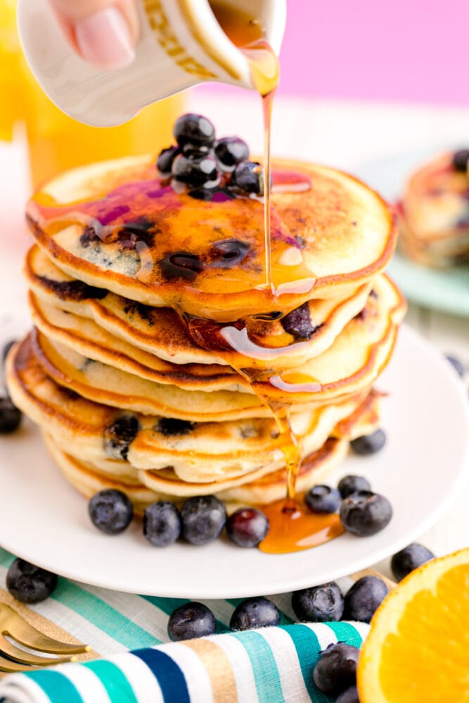 picture of blueberry pancakes with syrup in a stack 
