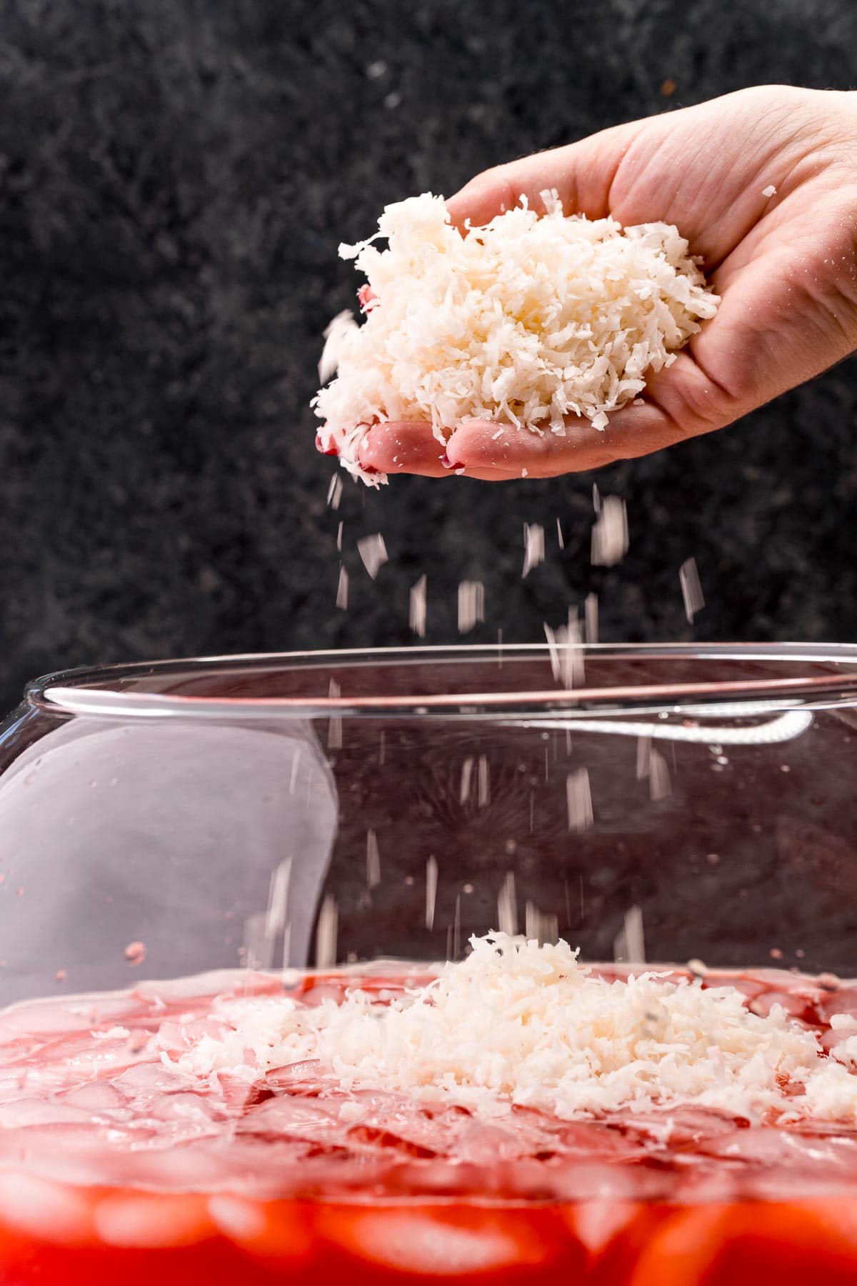 picture of shredded coconut being added into punch bowl
