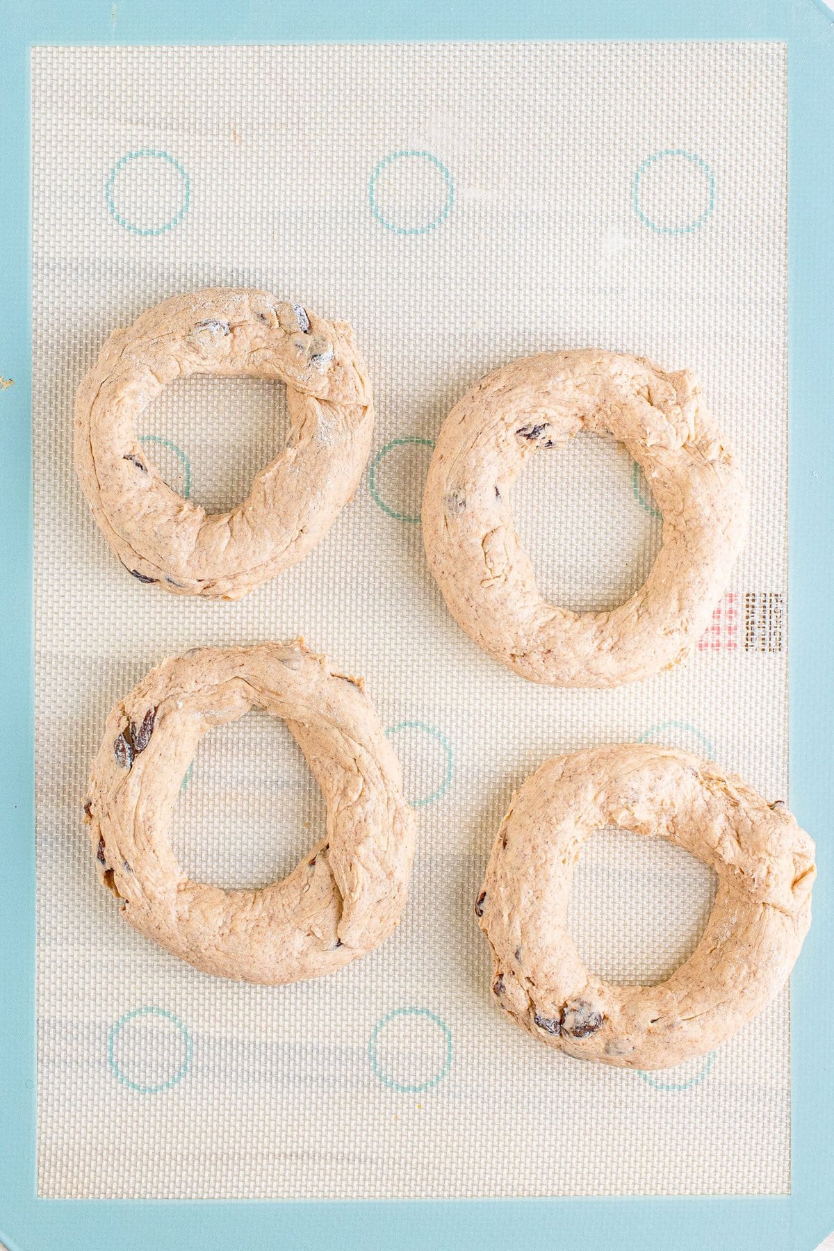 Four chocolate chip cookie dough rings on a baking sheet, air fried.