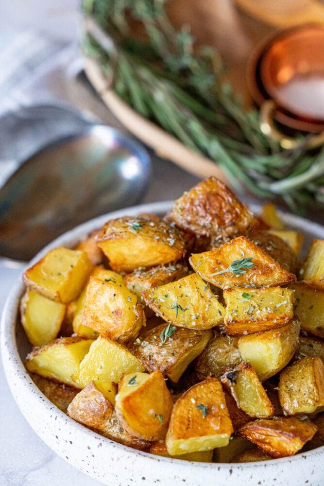 picture of crispy potatoes in a white bowl on a table