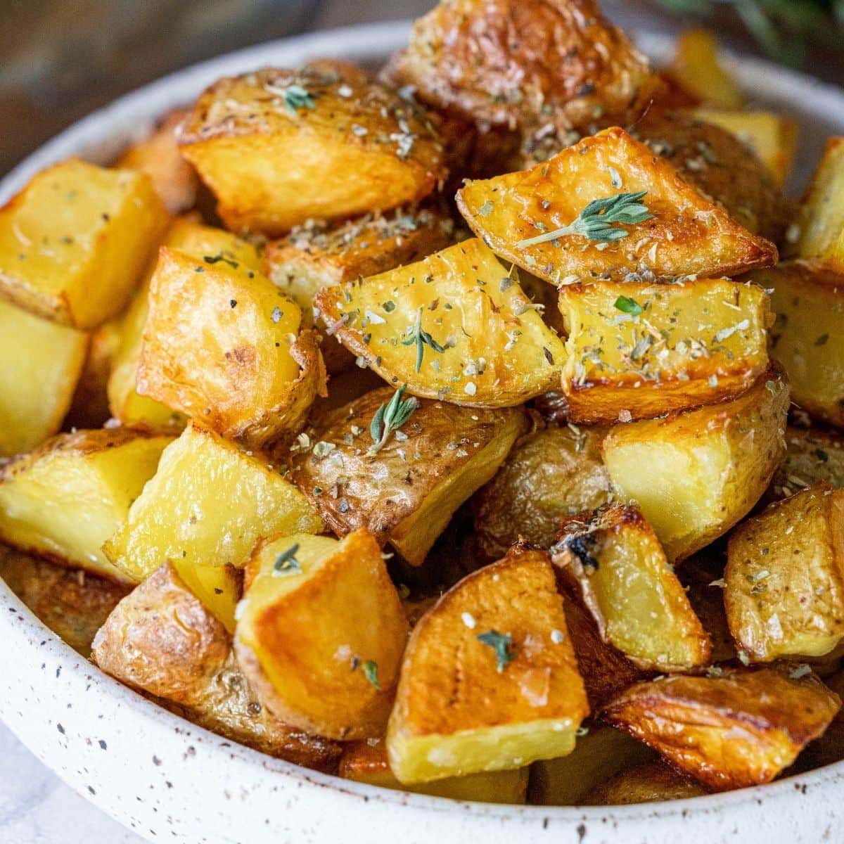 picture of crispy roasted potatoes in a white bowl