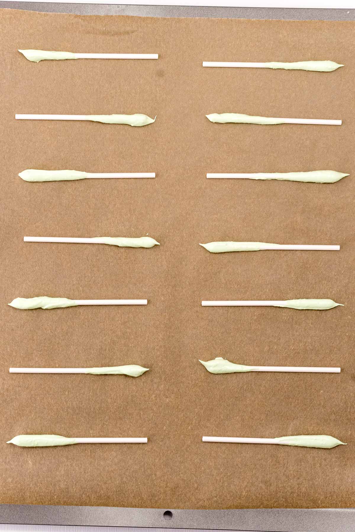 picture of christmas tree pop base being piped onto parchment paper