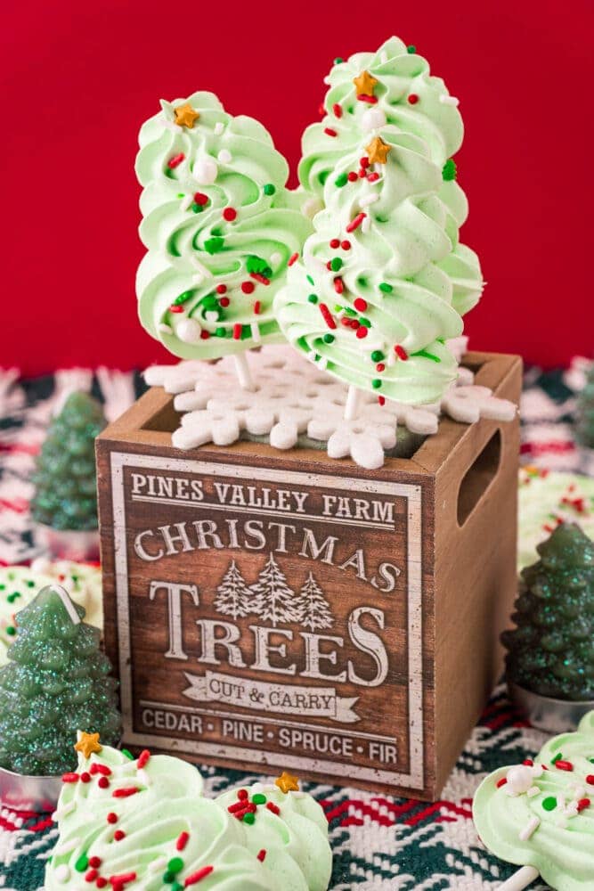 picture of meringue christmas tree cookie pops on a wooden box