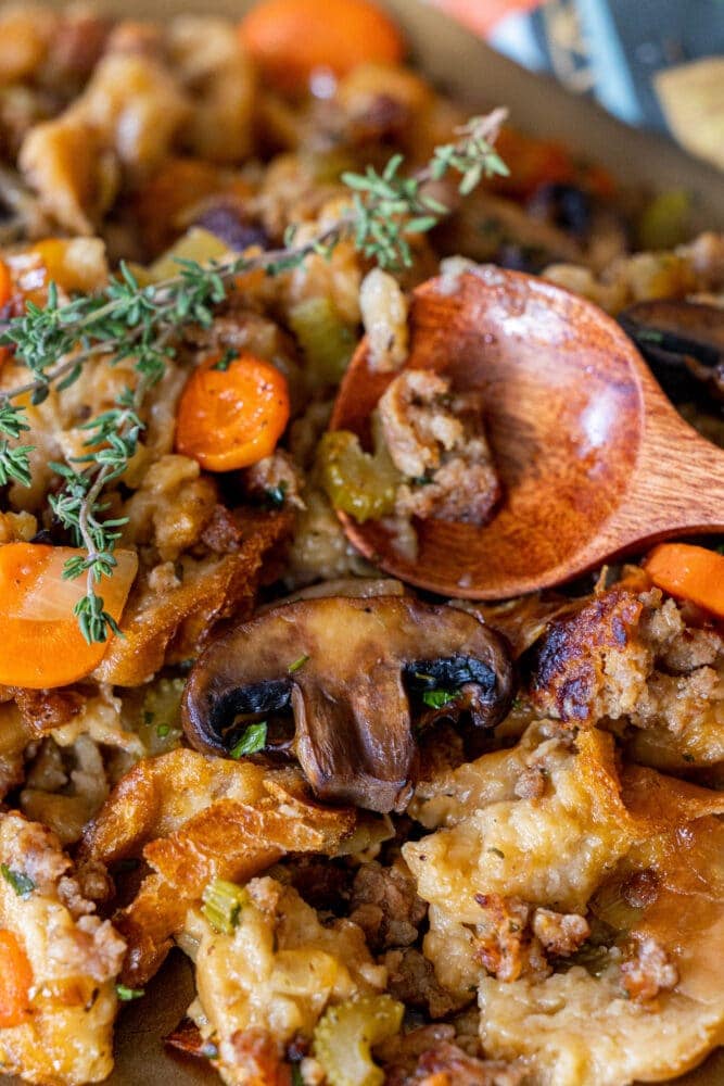 picture of sausage and mushroom stuffing with a serving spoon