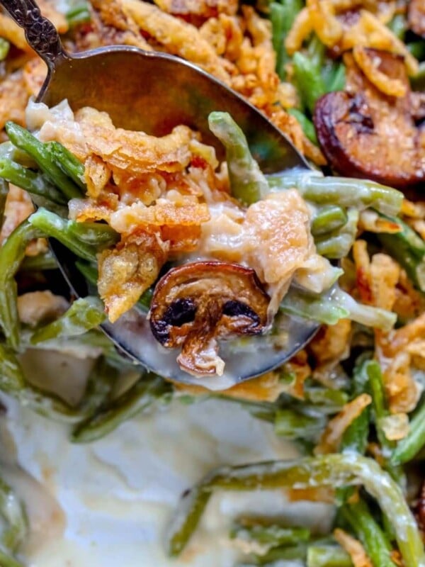 picture of spoon scooping green bean casserole from a baking dish